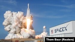 SpaceX компаниясының Falcon Heavy зымыранының ұшып бара жатқан сәті. Көрнекі сурет.