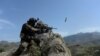 An Afghan security force personnel fires during an ongoing an operation against Islamic State (IS) militants in the Achin district of Nangarhar Province in April.