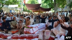 Pakistani Shi'ite Muslims stage a protest against the killing of their community members after twin bombing blasts on June 24 at a market in Parachinar, the capital of Kurram tribal district.