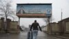 An Afghan migrant who was deported from Germany arrives with his belongings at the international airport in Kabul. (file photo)