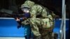 Иллюстрационное фото. Пророссийский боевик позирует для фотографии с ребенком. Донбас, апрель 2014 года