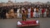 People gather to offer funeral prayers by the body of a Pakistani prisoner executed in January 2015. Pakistan lifted a six-year moratorium on the death penalty after militants killed more than 150 people at a school in the northwestern city of Peshawar in December 2014. 